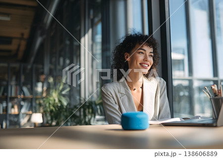 Professional using voice AI assistant in office environment, natural lighting 138606889