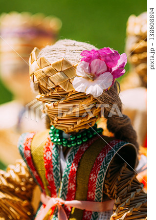 Colorful Belarusian Straw Dolls At The Market In Belarus. Faceless handmade woven straw doll with colorful clothes and flower. Colorful Belarusian Straw Dolls At The Market In Belarus. Faceless handmade woven straw doll with colorful clothes and flower. 138608894