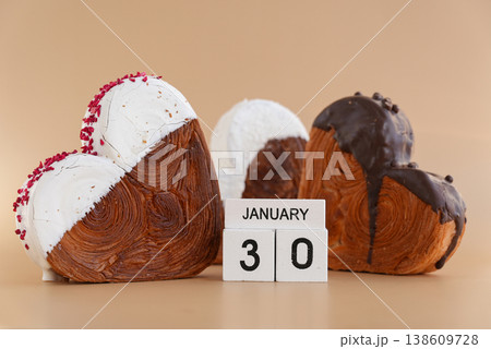 Calendar date 30 January national croissant day greeting card Delicious fresh croissant topped with colorful flavor Ganache. Creation unique heart shape bakery. Puff pastry holiday love gift present Calendar date 30 January national croissant day greeting card Delicious fresh croissant topped with colorful flavor Ganache. Creation unique heart shape bakery. Puff pastry holiday love gift present 138609728