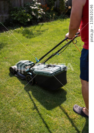 Lawn mowing in the garden, cutting green grass in the summer 138610146