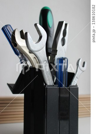 Bunch Of Colored Pliers, Screwdrivers And Steel Wrenches In Table Tool Holder Vertical Stock Photo Bunch Of Colored Pliers, Screwdrivers And Steel Wrenches In Table Tool Holder Vertical Stock Photo 138610182