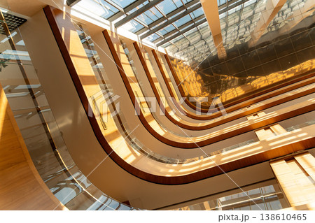 Modern atrium interior with curved balconies Modern atrium interior with curved balconies 138610465