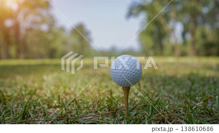 Golf balls on a green lawn in a beautiful golf course with morning sunshine. Golf balls on a green lawn in a beautiful golf course with morning sunshine. 138610686