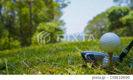 Golf clubs and golf balls on a green lawn in a beautiful golf course with morning sunshine. Golf clubs and golf balls on a green lawn in a beautiful golf course with morning sunshine. 138610690