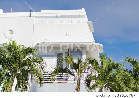 Apartment building with balcony palm trees. Low angle view of white building. Residential building architecture. Architectural exterior. House exterior fragment. Modern apartment building Apartment building with balcony palm trees. Low angle view of white building. Residential building architecture. Architectural exterior. House exterior fragment. Modern apartment building 138610767