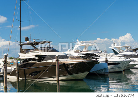 Luxury lifestyle. Vacations on summer. Yacht at sea port. Luxury boat motor yacht in marina on Biscayne Bay. Sailboat moored to pier in yacht marina. Sailing and yachting tourism. Motor yacht Luxury lifestyle. Vacations on summer. Yacht at sea port. Luxury boat motor yacht in marina on Biscayne Bay. Sailboat moored to pier in yacht marina. Sailing and yachting tourism. Motor yacht 138610774