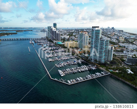 Luxurious yacht marina. Luxury boat harbor. Marina in Miami Beach, Florida USA. Yacht boat docked on sea Biscayne bay. Downtown Miami Marina with luxury yacht boat. Summer vacation. Aerial skyline 138610813