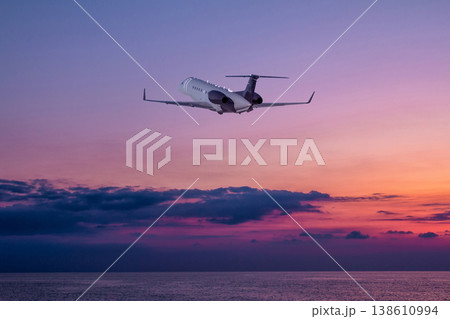 Private jet take off over the sea against the backdrop of picturesque sunrise sky Private jet take off over the sea against the backdrop of picturesque sunrise sky 138610994