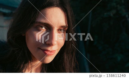 Smiling young woman close portrait in warm natural outdoor light Smiling young woman close portrait in warm natural outdoor light 138611240