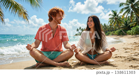 Couple meditating together on the beach with serene smile. 138611303