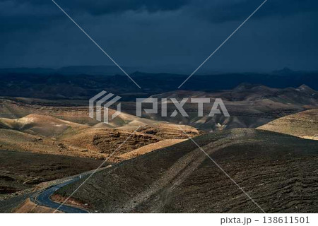 Desert canyon landscape with rocky cliffs and rugged mountain terrain 138611501