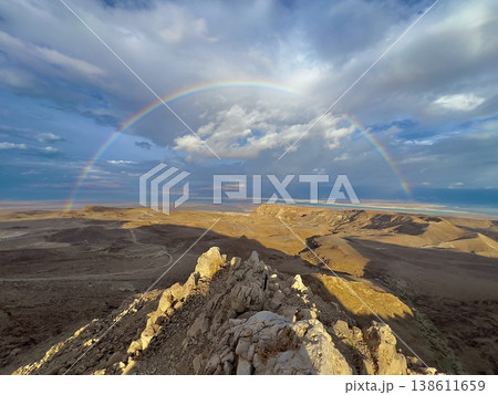 Dramatic rainbow over desert landscape with storm clouds and sea view 138611659