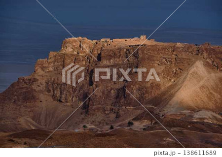 Dramatic desert coastline landscape with storm clouds over calm sea Dramatic desert coastline landscape with storm clouds over calm sea 138611689