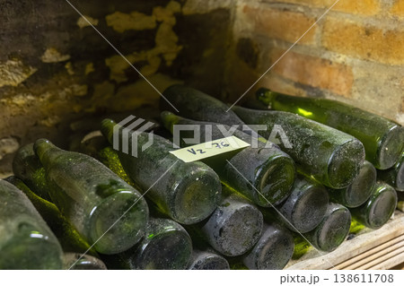 Dusty wine bottles aging in an old Znojmo cellar Dusty wine bottles aging in an old Znojmo cellar 138611708
