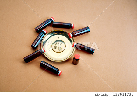 Vials and liquid on gold plate for medical research 138611736