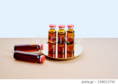 Medical vials containing vaccine on a golden tray Medical vials containing vaccine on a golden tray 138611742
