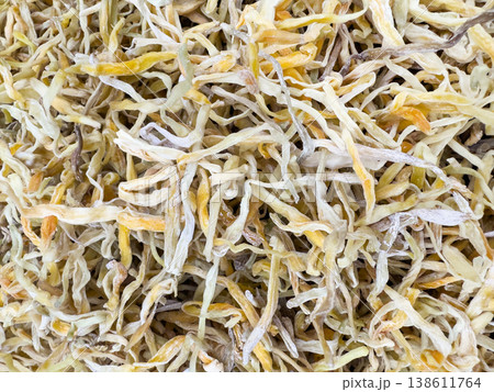 Golden needles and daylily buds dried and piled close together. Golden needles and daylily buds dried and piled close together. 138611764