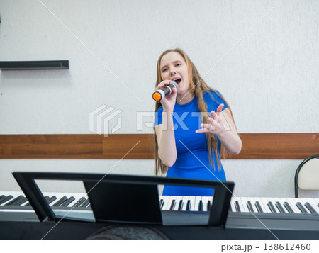 Caucasian woman singing into microphone. Caucasian woman singing into microphone. 138612460