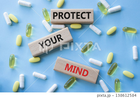 PROTECT YOUR MIND symbol. Concept words PROTECT YOUR MIND on wooden blocks. Beautiful blue background with pills. Healthcare and PROTECT YOUR MIND concept. Copy space. PROTECT YOUR MIND symbol. Concept words PROTECT YOUR MIND on wooden blocks. Beautiful blue background with pills. Healthcare and PROTECT YOUR MIND concept. Copy space. 138612584