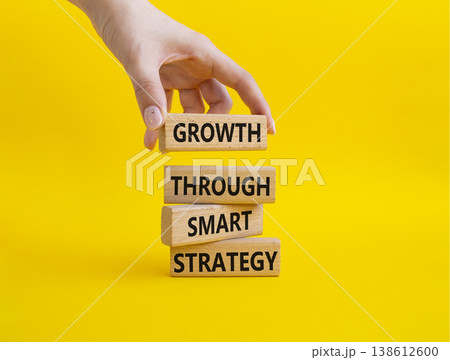 Smart strategy symbol. Wooden blocks with words Growth through smart strategy. Businessman hand. Beautiful yellow background. Business and Smart strategy concept. Copy space 138612600