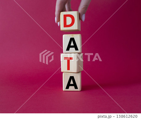 Data symbol. Concept word Data on wooden cubes. Businessman hand. Beautiful red background. Business and Data concept. Copy space. 138612620