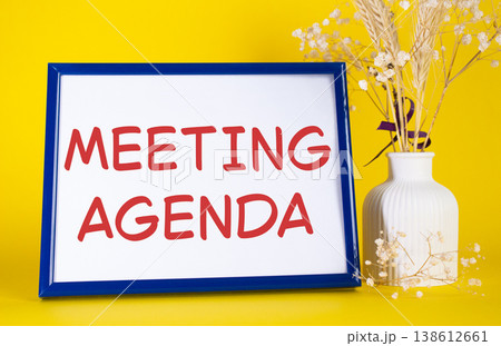 Meeting agenda symbol. Concept words Meeting agenda on beautiful wooden picture frame. Beautiful yellow background with flower vase. Business and Meeting agenda concept. Copy space. Meeting agenda symbol. Concept words Meeting agenda on beautiful wooden picture frame. Beautiful yellow background with flower vase. Business and Meeting agenda concept. Copy space. 138612661