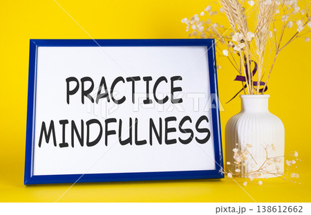 Mindfulness symbol. Concept words Practice Mindfulness on beautiful wooden picture frame. Beautiful yellow background with flower vase. Medical and Psychology concept. Copy space. Mindfulness symbol. Concept words Practice Mindfulness on beautiful wooden picture frame. Beautiful yellow background with flower vase. Medical and Psychology concept. Copy space. 138612662