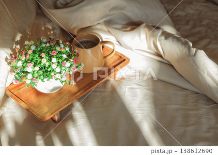 Breakfast in bed with coffee mug and potted plant 138612690