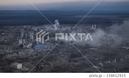 Aerial view of a city devastated by war, showing destroyed buildings and smoke plumes in Middle East region Iranian city Aerial view of a city devastated by war, showing destroyed buildings and smoke plumes in Middle East region Iranian city 138612915