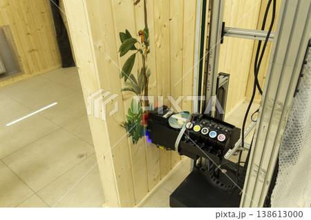 The device in the image is a vertical wall printer, a specialized inkjet printer designed to print directly onto vertical surfaces like walls The device in the image is a vertical wall printer, a specialized inkjet printer designed to print directly onto vertical surfaces like walls 138613000