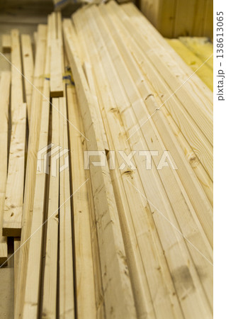The image shows a stack of raw dimensional lumber planks, likely intended for construction or carpentry projects. The image shows a stack of raw dimensional lumber planks, likely intended for construction or carpentry projects. 138613065