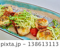 A multi-sensory gourmet appetizer featuring seared scallops with melted cheese 138613113