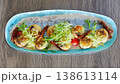 A multi-sensory gourmet appetizer featuring seared scallops with melted cheese 138613114