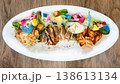 A multi-sensory seafood platter featuring grilled fish steaks and salmon 138613134