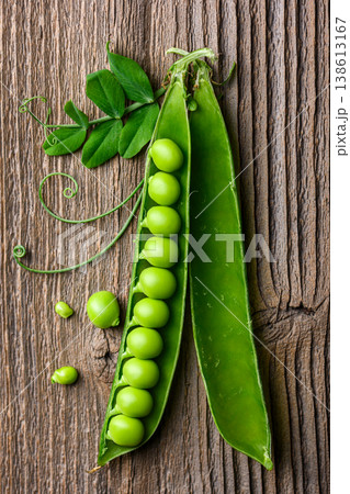 Green peas and pods arranged on rustic wooden background Green peas and pods arranged on rustic wooden background 138613167