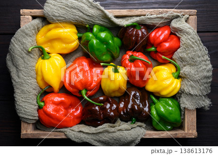 Mixed habanero peppers in wooden crate 138613176