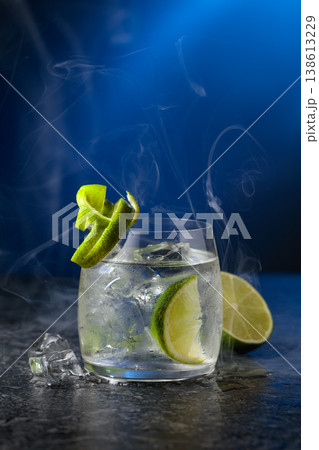 Vodka with lime and ice cubes in a fogged up glass. 138613229