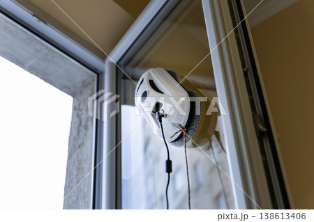 Close up of a White Window Cleaning Robot Working on Glass 138613406