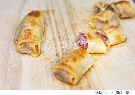 Delicious Pan-Fried Crepe Rolls with Minced Meat Filling on Wood Delicious Pan-Fried Crepe Rolls with Minced Meat Filling on Wood 138613480