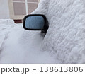 Snow blankets a parked car in harsh winter weather conditions 138613806