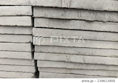 Stacked concrete slabs ready for construction in a busy urban area 138613808