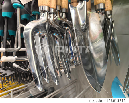 Shiny gardening tools hanging in a colorful display at the local store 138613812