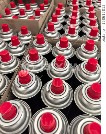 Spray paint cans stacked in rows at a vibrant art supply store 138613813