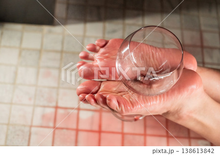 Foot fetish. A woman holds a wine glass in the shower. Foot fetish. A woman holds a wine glass in the shower. 138613842