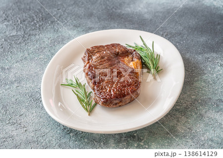 Perfectly grilled beef steak with rosemary on white plate premium restaurant presentation 138614129