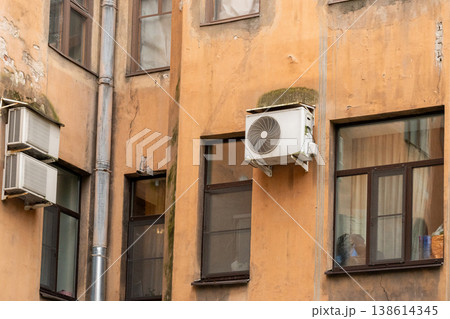 air conditioning on facade of building, air cooling in hot weather. air conditioning on facade of building, air cooling in hot weather. 138614345