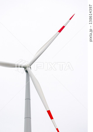 wind turbines in field rotate their blades to generate energy. windmill on spacious green field. 138614397