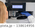 Automated liquid chromatography system performing injection of a brown sample vial at a laboratory workstation. 138614956