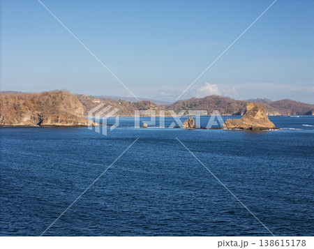 Coastline view with rocks and clear water under blue sky Coastline view with rocks and clear water under blue sky 138615178