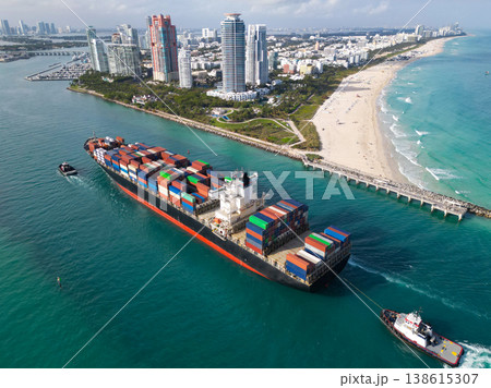Cargo ship with container in Miami, aerial. Freight container on cargo vessel. Cargo ship vessel leaving port. Container ship. Export and import. Cargo business. Port of Miami. Ocean-crossing vessel 138615307